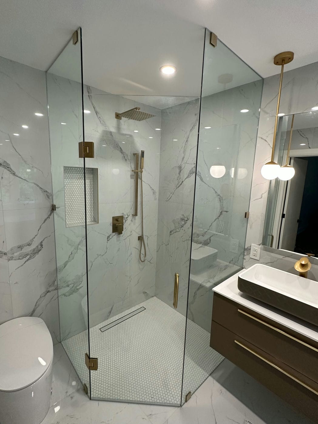 frameless glass shower with bronze accessories