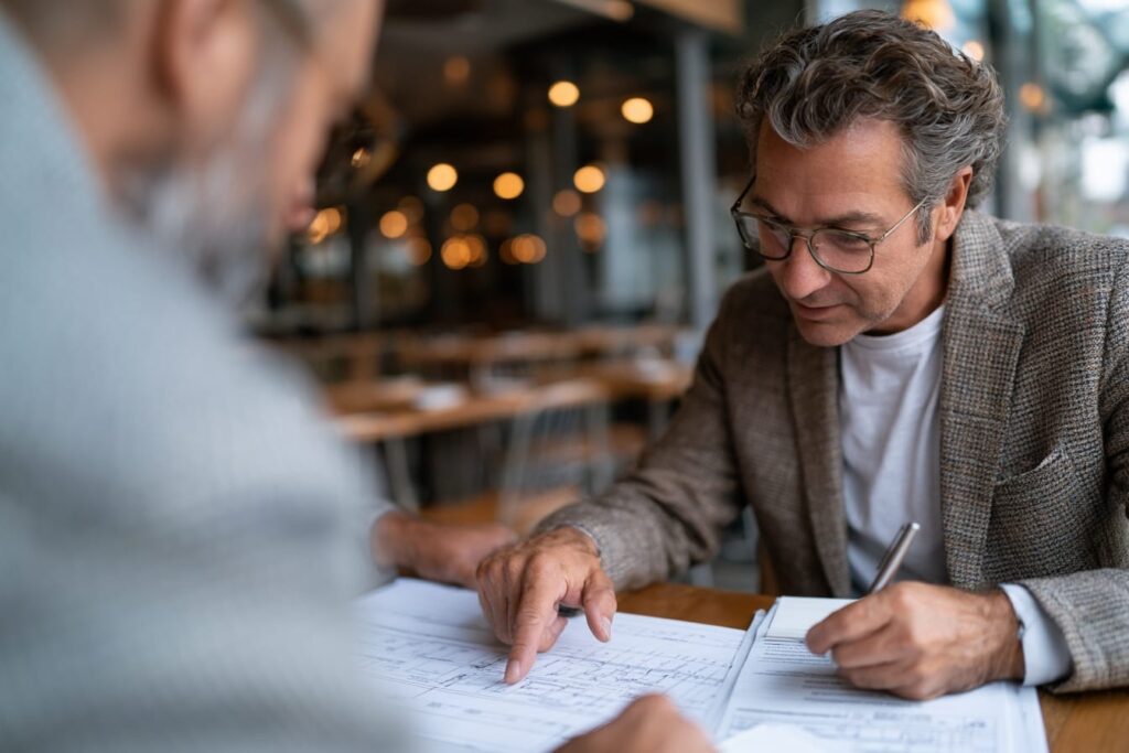 Restaurant owner and architect reviewing patio application requirements and approval path
