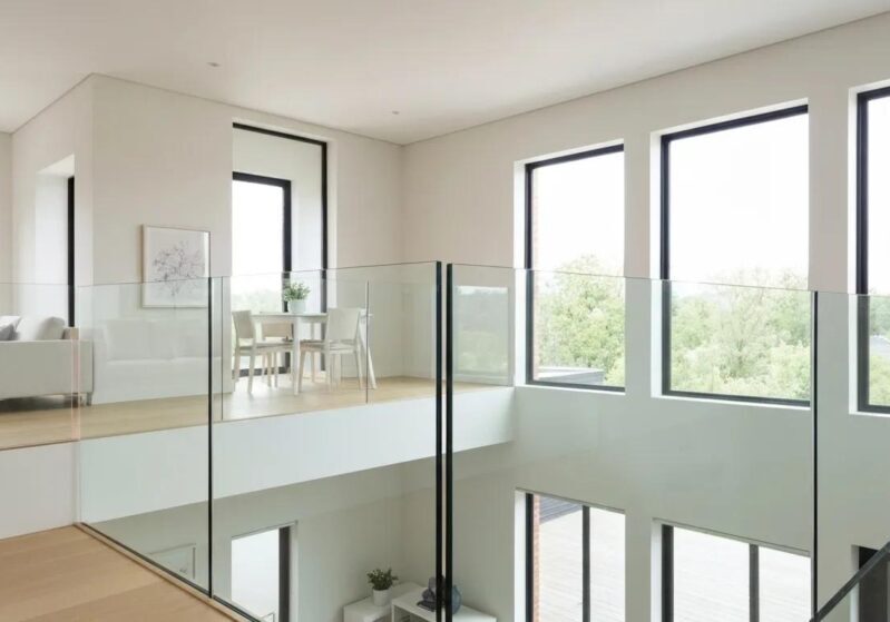 Elegant indoor glass railings in a bright modern home interior, showcasing transparency and aesthetic appeal